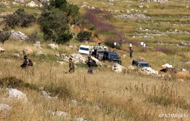 Israeli soldiers stand guard during a demonstration by Palestinian and foreign protesters against Jewish settlements in the northern West Bank village of Iraq Burin, near Nablus, Saturday, May 21, 2011. Photo by Wagdi Es...