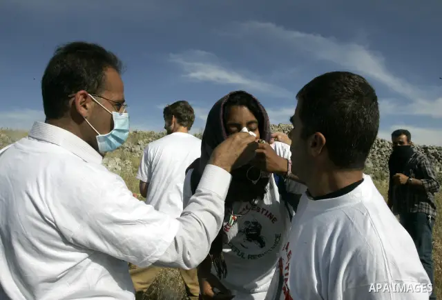 Palestinian protesters help wounded youth, during a demonstration against Jewish settlements in the northern West Bank village of Iraq Burin, near Nablus, Saturday, May 21, 2011. Photo by Wagdi Eshtayah