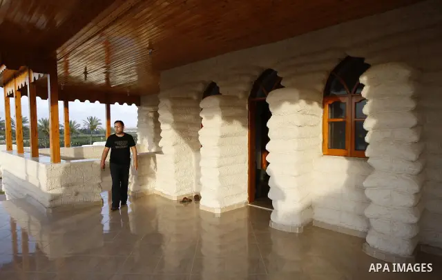 A Palestinian man stands at his resort which was built from sacks of sand in the southern Gaza Strip town of Khan Younis on May 23 ,2011. The man used the sacks of sand instead of cement, steel and gravel because of the...