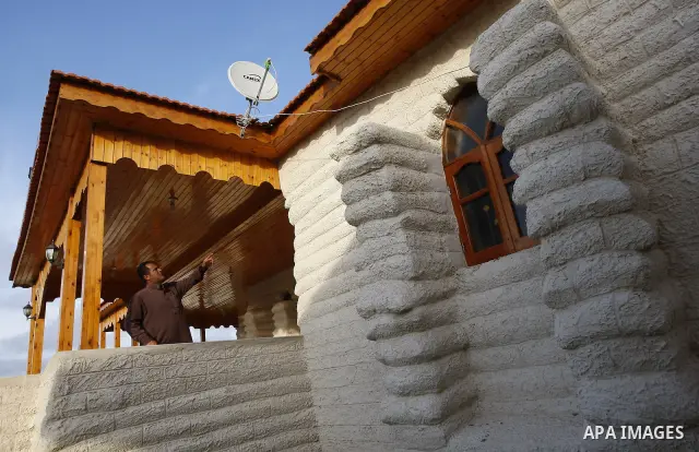 A Palestinian man stands at his resort which was built from sacks of sand in the southern Gaza Strip town of Khan Younis on May 23 ,2011. The man used the sacks of sand instead of cement, steel and gravel because of the...