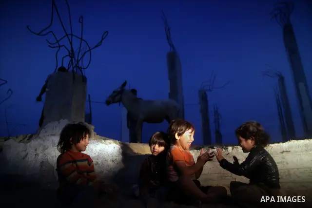 Palestinian children play outside a tent which was erected outside their family house in Jabaliya refugee camp, in the northern Gaza Strip, 24 May 2011. Their house was destroyed during the Israeli assault on Gaza in lat...