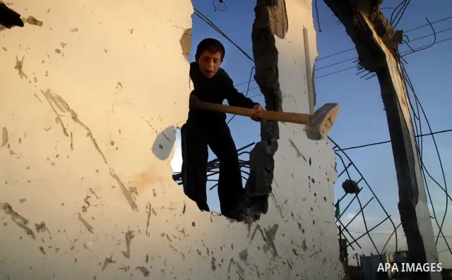 Palestinian children play outside a tent which was erected outside their family house in Jabaliya refugee camp, in the northern Gaza Strip, 24 May 2011. Their house was destroyed during the Israeli assault on Gaza in lat...