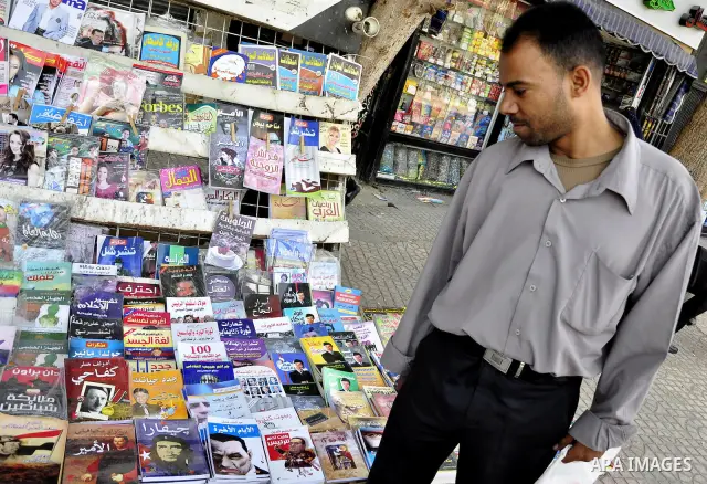 An Egyptian man looks at books and magazines with a front page picture of ousted Egyptian leader Hosni Mubarak on May 25, 2011, a day after the State prosecutor announced that Mubarak and his two sons would face trial in...