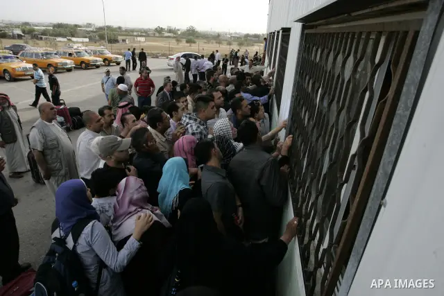 Palestinians wait to cross into Egypt through the Rafah border terminal in the southern Gaza Strip on May 26, 2011, a day after the official MENA news agency reported that Egypt will open the crossing on a daily basis st...