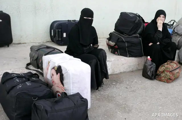 Palestinian women wait to cross into Egypt through the Rafah border terminal in the southern Gaza Strip on May 26, 2011, a day after the official MENA news agency reported that Egypt will open the crossing on a daily bas...