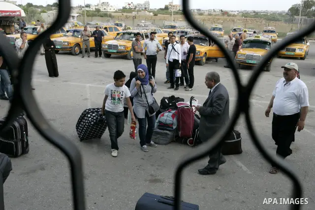 Palestinians wait to cross into Egypt through the Rafah border terminal in the southern Gaza Strip on May 26, 2011, a day after the official MENA news agency reported that Egypt will open the crossing on a daily basis st...