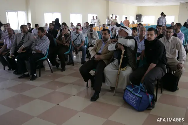 Palestinians wait to cross into Egypt through the Rafah border terminal in the southern Gaza Strip on May 26, 2011, a day after the official MENA news agency reported that Egypt will open the crossing on a daily basis st...