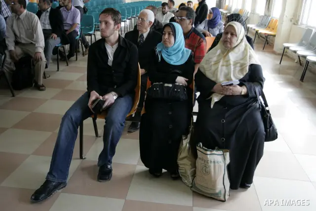 Palestinians wait to cross into Egypt through the Rafah border terminal in the southern Gaza Strip on May 26, 2011, a day after the official MENA news agency reported that Egypt will open the crossing on a daily basis st...