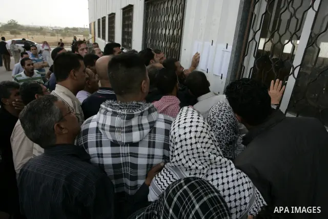 Palestinians wait to cross into Egypt through the Rafah border terminal in the southern Gaza Strip on May 26, 2011, a day after the official MENA news agency reported that Egypt will open the crossing on a daily basis st...