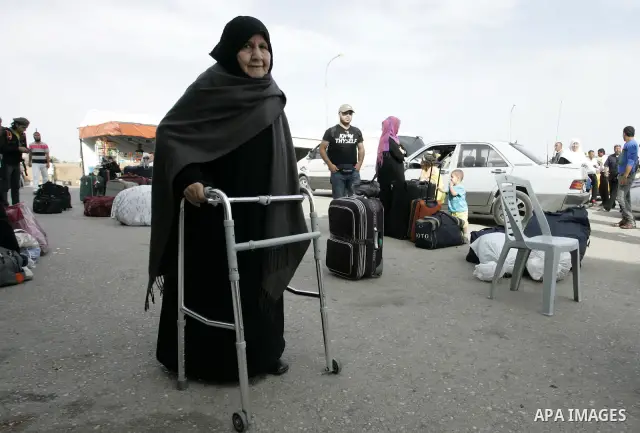 Palestinian women wait to cross into Egypt through the Rafah border terminal in the southern Gaza Strip on May 26, 2011, a day after the official MENA news agency reported that Egypt will open the crossing on a daily bas...