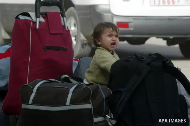 Palestinian child waits to cross into Egypt through the Rafah border terminal in the southern Gaza Strip on May 26, 2011, a day after the official MENA news agency reported that Egypt will open the crossing on a daily ba...