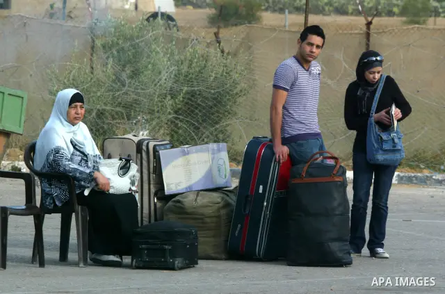 Palestinians wait to cross into Egypt through the Rafah border terminal in the southern Gaza Strip on May 26, 2011, a day after the official MENA news agency reported that Egypt will open the crossing on a daily basis st...