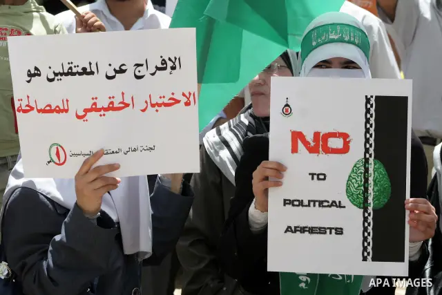 Hamas members of the Palestinian Legislative Council (PLC) take part with Palestinian supporters of the Hamas Islamist movement during a rally calling for the release of Palestinians being held in West Bank and Gaza Stri...