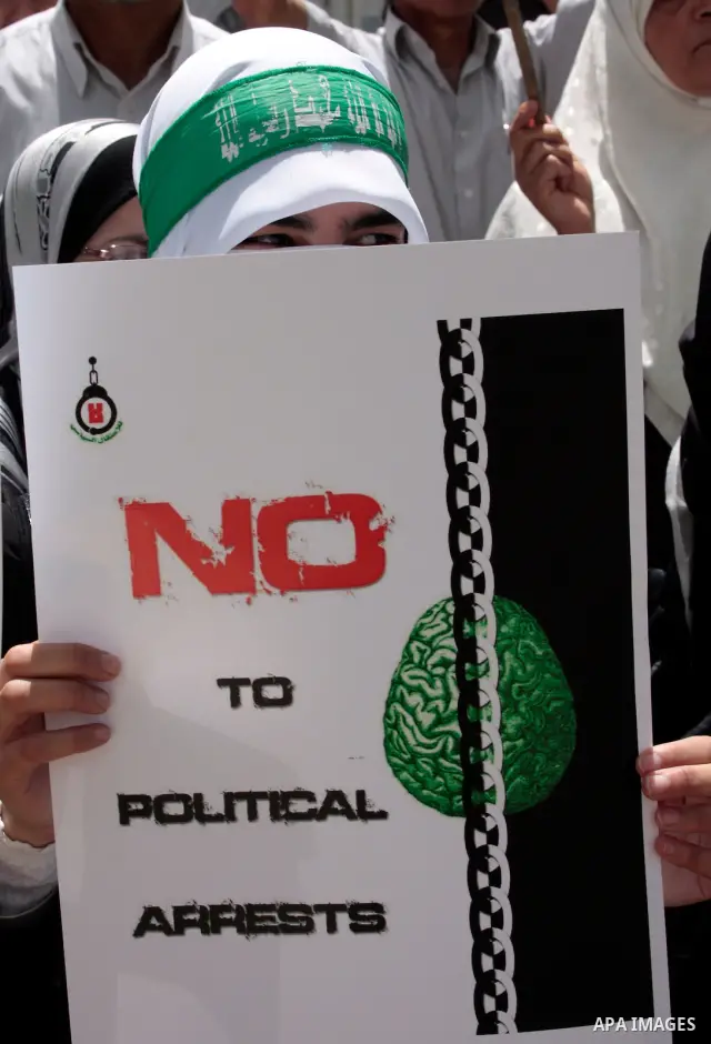 Hamas members of the Palestinian Legislative Council (PLC) take part with Palestinian supporters of the Hamas Islamist movement during a rally calling for the release of Palestinians being held in West Bank and Gaza Stri...