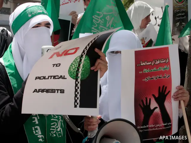 Hamas members of the Palestinian Legislative Council (PLC) take part with Palestinian supporters of the Hamas Islamist movement during a rally calling for the release of Palestinians being held in West Bank and Gaza Stri...