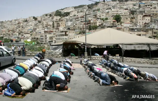 Palestinian Muslim worshipper attend Friday prayers near a protest tent in the mostly Arab neighbourhood of Silwan in east Jerusalem on May 27, 2011.. Photo by Mahfouz Abu Turk
