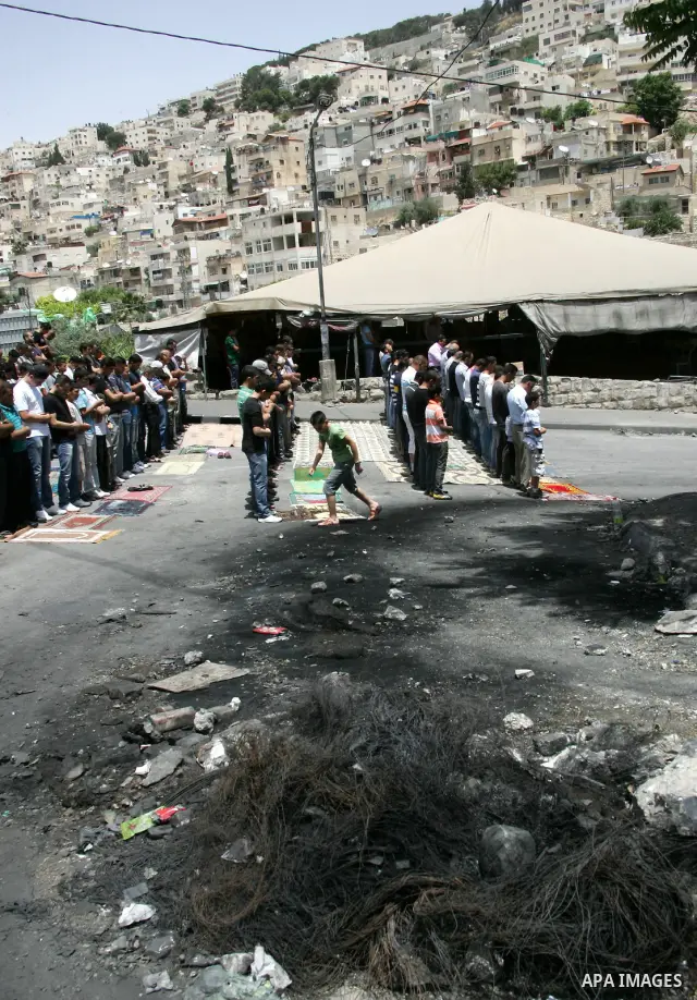 Palestinian Muslim worshipper attend Friday prayers near a protest tent in the mostly Arab neighbourhood of Silwan in east Jerusalem on May 27, 2011.. Photo by Mahfouz Abu Turk