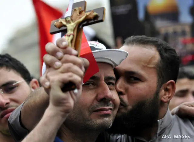 An Egyptian Christian protester hugs a Muslim protester during a protest at Tahrir Square in Cairo, Egypt Friday, May 27, 2011. Thousands of protesters poured into downtown Cairo's Tahrir Square Friday for what they call...