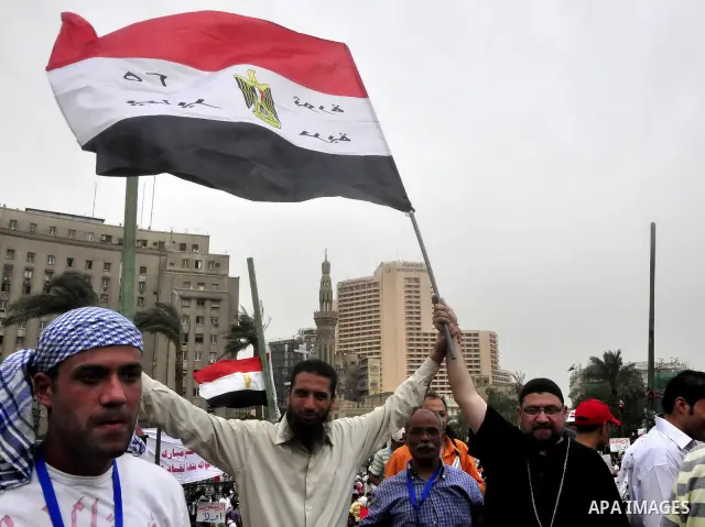 An Egyptian Christian protester hugs a Muslim protester during a protest at Tahrir Square in Cairo, Egypt Friday, May 27, 2011. Thousands of protesters poured into downtown Cairo's Tahrir Square Friday for what they call...
