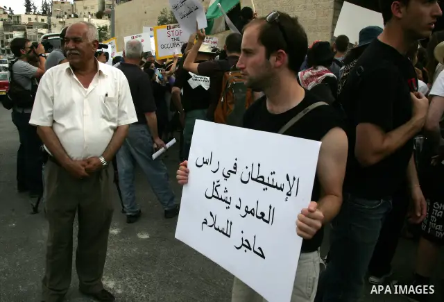 Left wing Israelis, Palestinians and international activists protest before the dedication ceremony for the Jewish neighborhood of Maale Hazeitim, inside the east Jerusalem area of Ras el Amud, Friday, May 27, 2011. Duri...