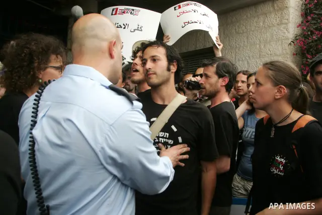 Left wing Israelis, Palestinians and international activists protest before the dedication ceremony for the Jewish neighborhood of Maale Hazeitim, inside the east Jerusalem area of Ras el Amud, Friday, May 27, 2011. Duri...