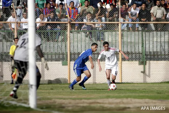 Palestinian Shabab Rafah player vies with Al-Shatea soccer club player during Gaza Strip league, in the southern Gaza Strip town Rafah on May 27,2011. The match ended 0-0.. Photo by Ali Jadallah