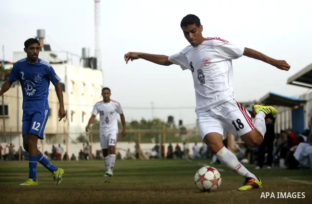 Palestinian Shabab Rafah player vies with Al-Shatea soccer club player during Gaza Strip league, in the southern Gaza Strip town Rafah on May 27,2011. The match ended 0-0.. Photo by Ali Jadallah