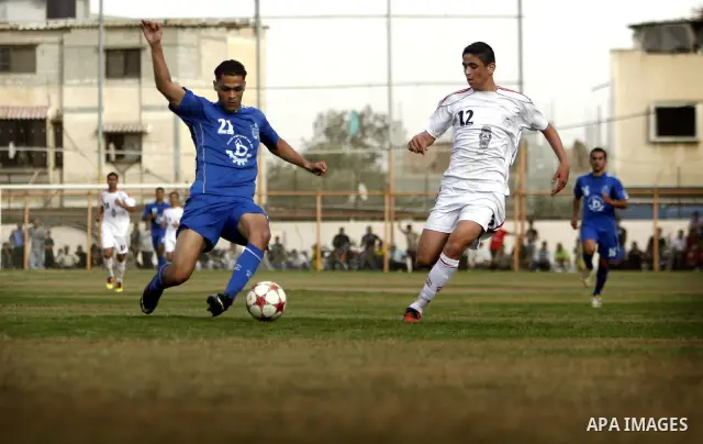 Palestinian Shabab Rafah player vies with Al-Shatea soccer club player during Gaza Strip league, in the southern Gaza Strip town Rafah on May 27,2011. The match ended 0-0.. Photo by Ali Jadallah