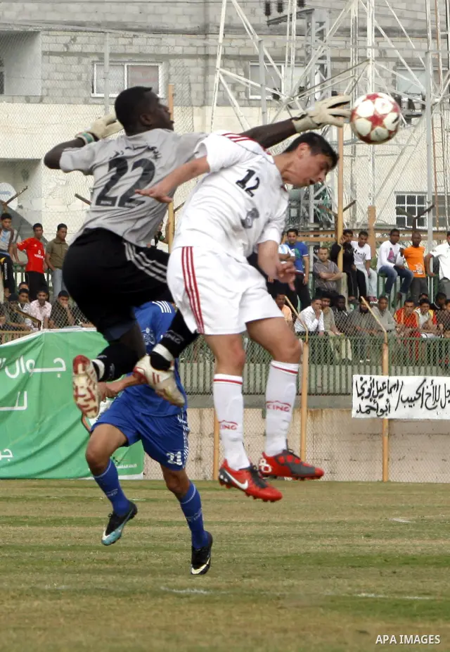 Palestinian Shabab Rafah player vies with Al-Shatea soccer club player during Gaza Strip league, in the southern Gaza Strip town Rafah on May 27,2011. The match ended 0-0.. Photo by Ali Jadallah