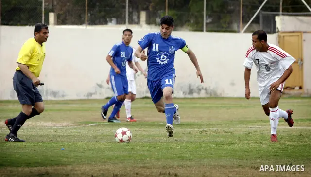 Palestinian Shabab Rafah player vies with Al-Shatea soccer club player during Gaza Strip league, in the southern Gaza Strip town Rafah on May 27,2011. The match ended 0-0.. Photo by Ali Jadallah