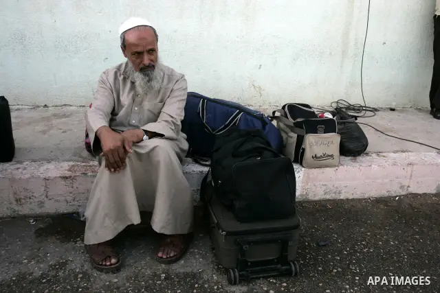 A Palestinian man waits to cross into Egypt through the Rafah border crossing in the southern Gaza Strip on May 28, 2011 as Egypt reopened the border, allowing people to cross freely for the first time in four years. Pho...