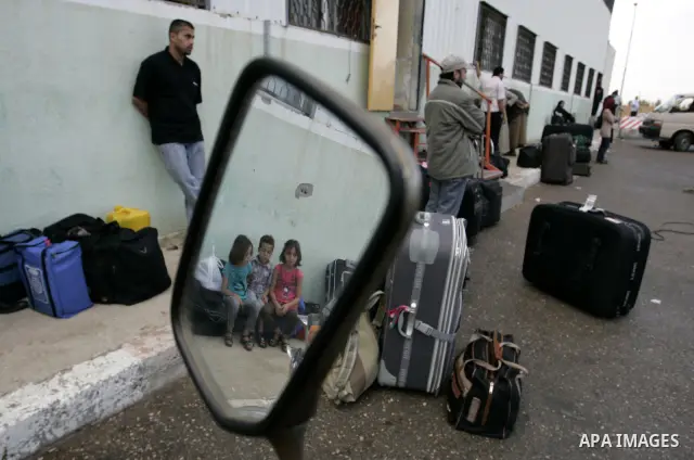 Palestinians wait to cross into Egypt through the Rafah border crossing in the southern Gaza Strip on May 28, 2011 as Egypt reopened the border, allowing people to cross freely for the first time in four years. Photo by...