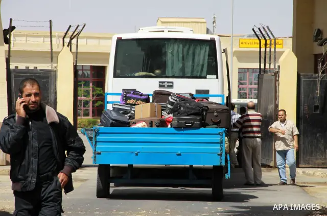Palestinians load their luggage as they cross into Egypt through the Rafah border crossing in the southern Gaza Strip on May 28, 2011 as Egypt reopened the border, allowing people to cross freely for the first time in fo...