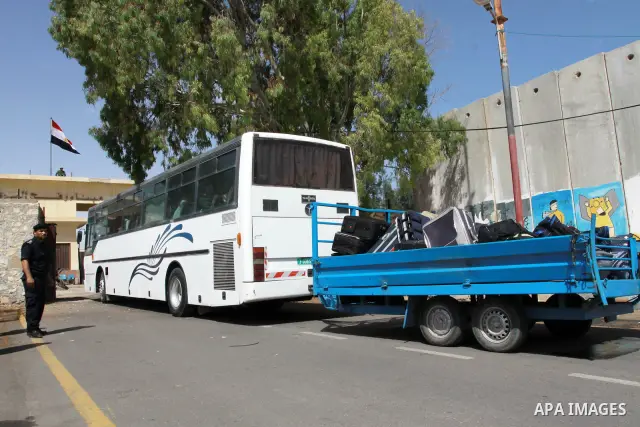 Palestinians load their luggage as they cross into Egypt through the Rafah border crossing in the southern Gaza Strip on May 28, 2011 as Egypt reopened the border, allowing people to cross freely for the first time in fo...