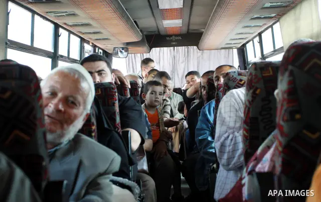Palestinians sit in a bus as they wait to cross into Egypt through the Rafah border crossing in the southern Gaza Strip on May 28, 2011 as Egypt reopened the border, allowing people to cross freely for the first time in...