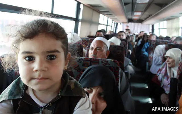 Palestinians sit in a bus as they wait to cross into Egypt through the Rafah border crossing in the southern Gaza Strip on May 28, 2011 as Egypt reopened the border, allowing people to cross freely for the first time in...