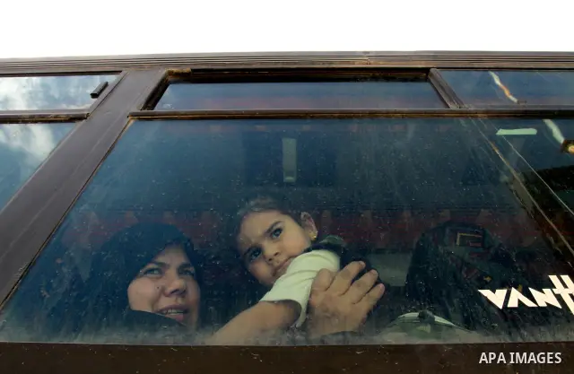 Palestinians sit in a bus as they wait to cross into Egypt through the Rafah border crossing in the southern Gaza Strip on May 28, 2011 as Egypt reopened the border, allowing people to cross freely for the first time in...