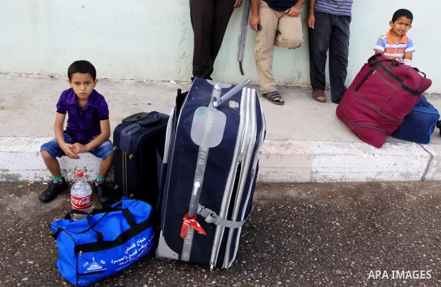 Palestinians wait to cross into Egypt through the Rafah border crossing in the southern Gaza Strip on May 28, 2011 as Egypt reopened the border, allowing people to cross freely for the first time in four years. Photo by...