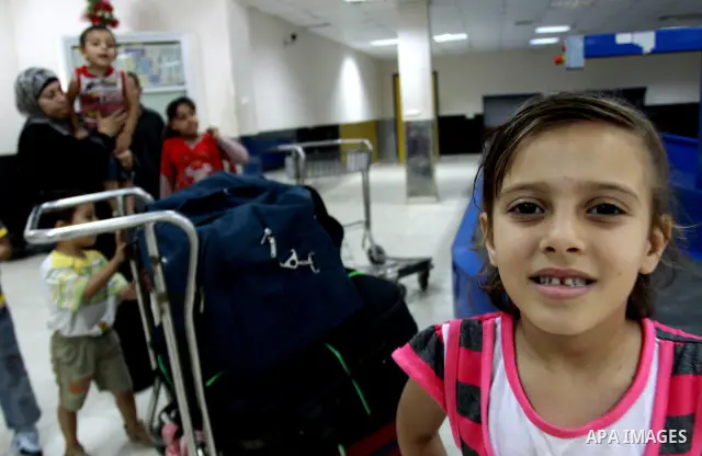 Palestinians returnees come through the Rafah border crossing in the southern Gaza Strip on May 28, 2011 as Egypt reopened the border, allowing people to cross freely for the first time in four years. Photo by Naaman Oma...