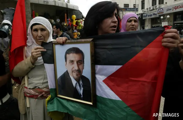 Palestinians women hold pictures of their relatives, during a protest calling for the release of Palestinian prisoners from Israeli jails, in the West Bank city of Nablus on May 28, 2011. Israel currently holds about 8,0...