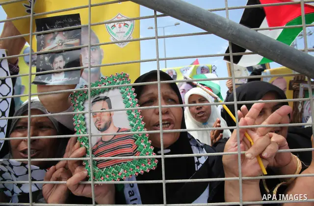 Palestinians women hold pictures of jailed relatives during a protest calling for their release from Israeli prisons near Erez crossing between Israel and the northern Gaza Strip on May 28, 2011. Photo by Yasser Fathi
