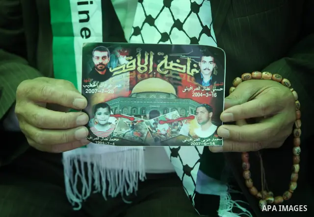 Palestinians women hold pictures of jailed relatives during a protest calling for their release from Israeli prisons near Erez crossing between Israel and the northern Gaza Strip on May 28, 2011. Photo by Yasser Fathi