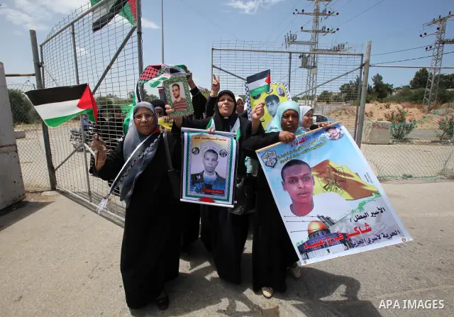 Palestinians women hold pictures of jailed relatives during a protest calling for their release from Israeli prisons near Erez crossing between Israel and the northern Gaza Strip on May 28, 2011. Photo by Yasser Fathi