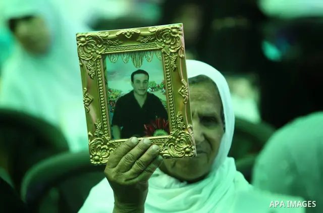 Palestinians women hold pictures of jailed relatives during a protest calling for their release from Israeli prisons near Erez crossing between Israel and the northern Gaza Strip on May 28, 2011. Photo by Yasser Fathi