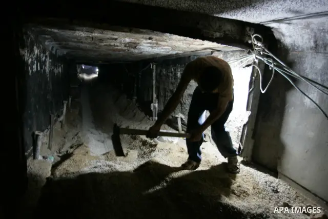 Palestinian men smuggle gravels into the Gaza Strip through a tunnel under the Egypt-Gaza border in Rafah on May 28, 2011. Egypt on Saturday reopened its Rafah border with the Gaza Strip, allowing people to cross freely...