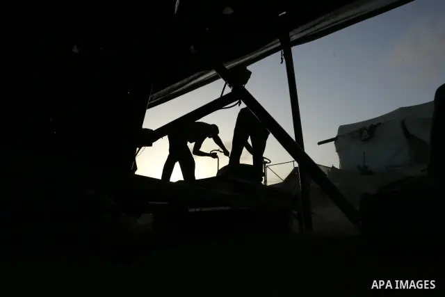 Palestinian men smuggle gravels into the Gaza Strip through a tunnel under the Egypt-Gaza border in Rafah on May 28, 2011. Egypt on Saturday reopened its Rafah border with the Gaza Strip, allowing people to cross freely...