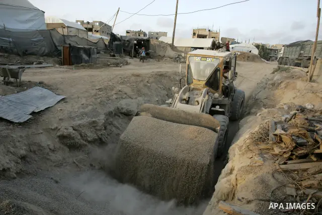 Palestinian men smuggle gravels into the Gaza Strip through a tunnel under the Egypt-Gaza border in Rafah on May 28, 2011. Egypt on Saturday reopened its Rafah border with the Gaza Strip, allowing people to cross freely...