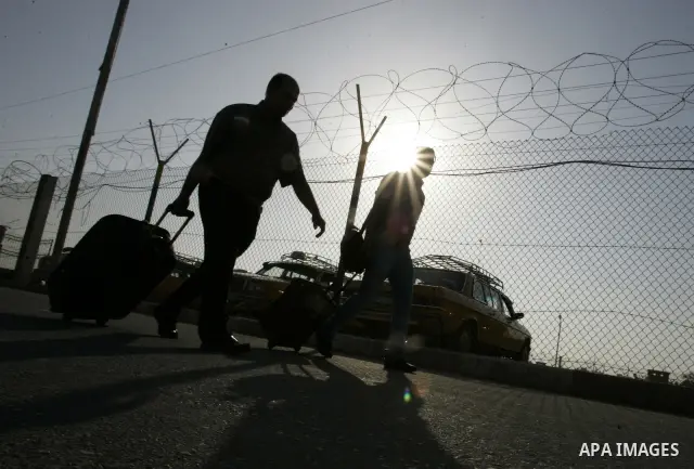 Palestinians wait to cross into Egypt through the Rafah border crossing in the southern Gaza Strip on May 30, 2011. Egypt eased travel restrictions for residents of Gaza from Saturday, and eroding a blockade that imposed...