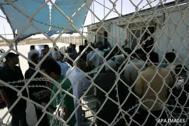 Palestinians wait to cross into Egypt through the Rafah border crossing in the southern Gaza Strip on May 30, 2011. Egypt eased travel restrictions for residents of Gaza from Saturday, and eroding a blockade that imposed...