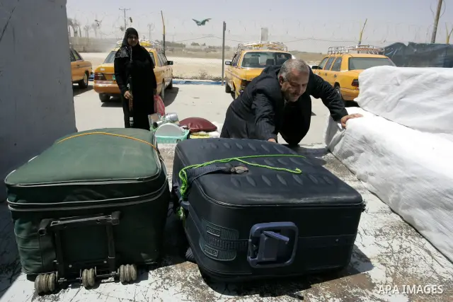 Palestinians load their luggage as they wait to cross into Egypt through the Rafah border crossing in the southern Gaza Strip on May 30, 2011. Egypt eased travel restrictions for residents of Gaza from Saturday, and erod...